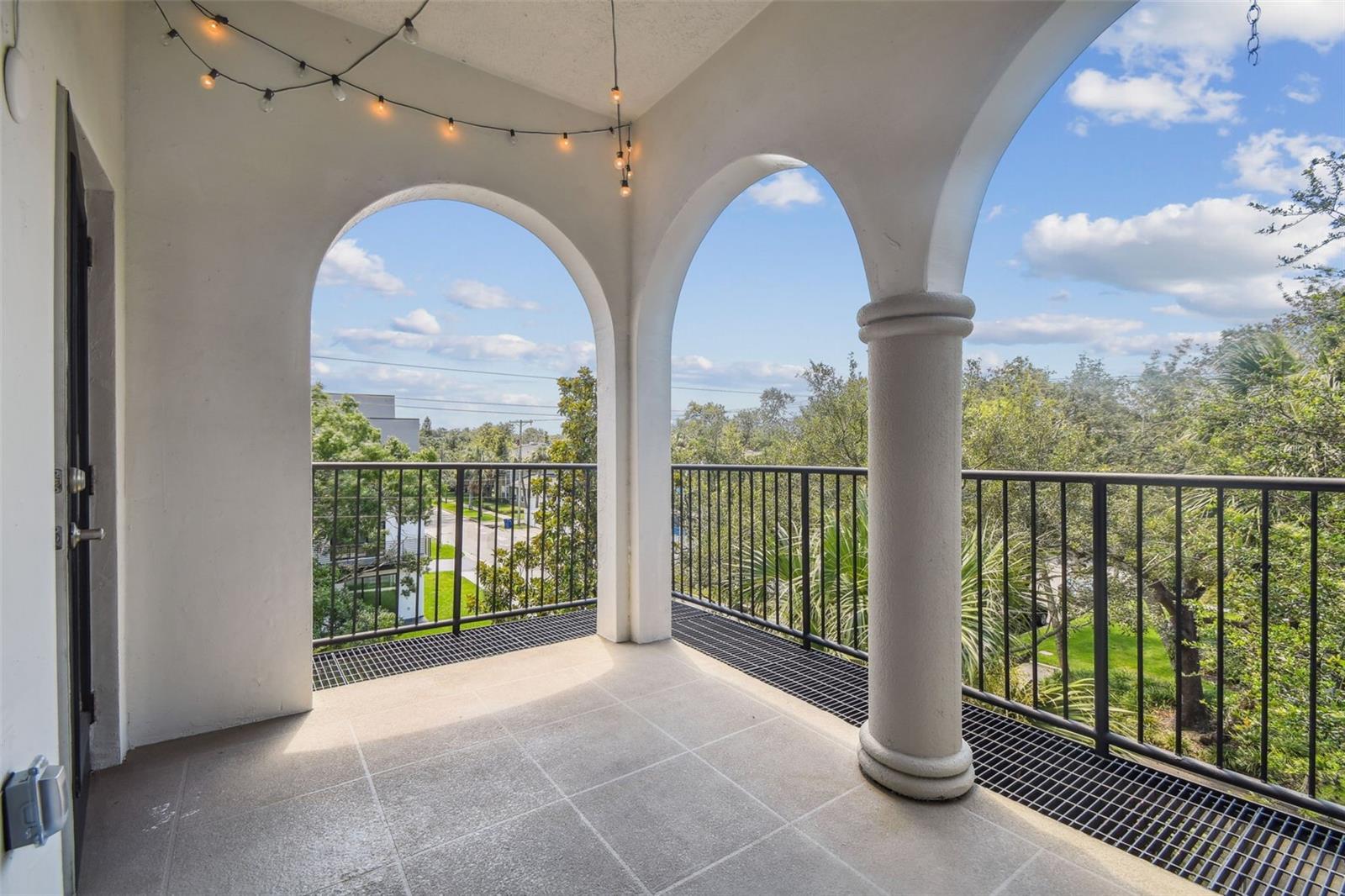 Over-sized private balcony with decorative archways and drainage.