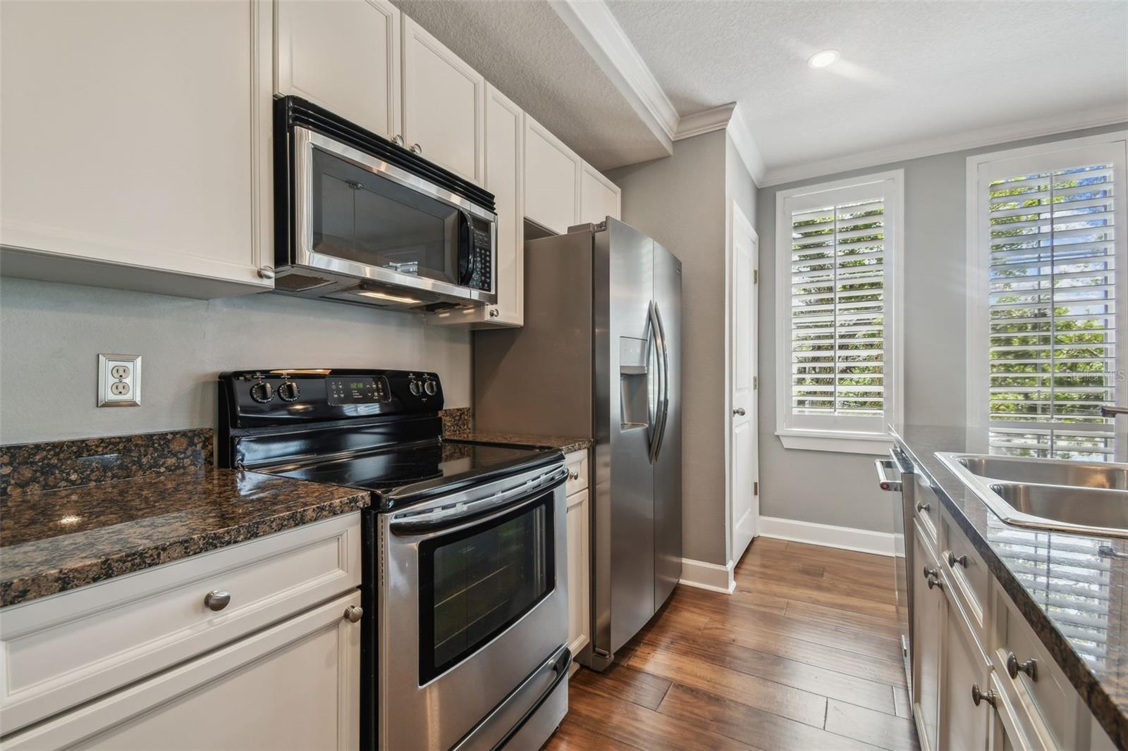 Stainless steel appliances and stone countertops.