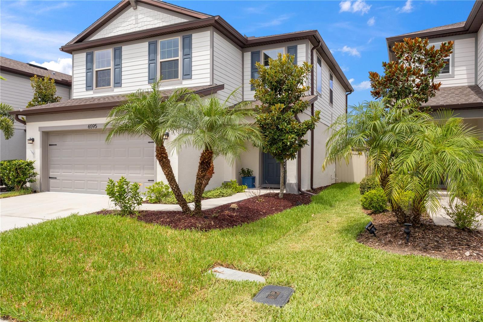 Walkway to front entry with tropical landscaping