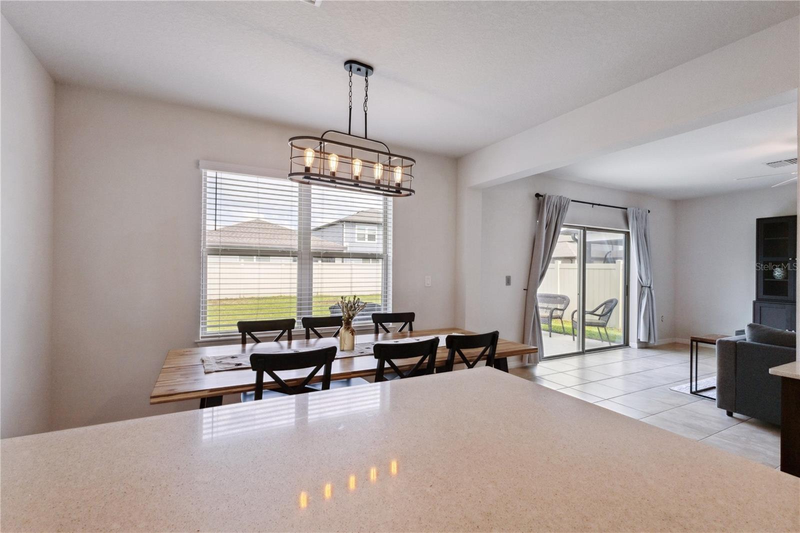 Kitchen dinette with windows looking out the backyard