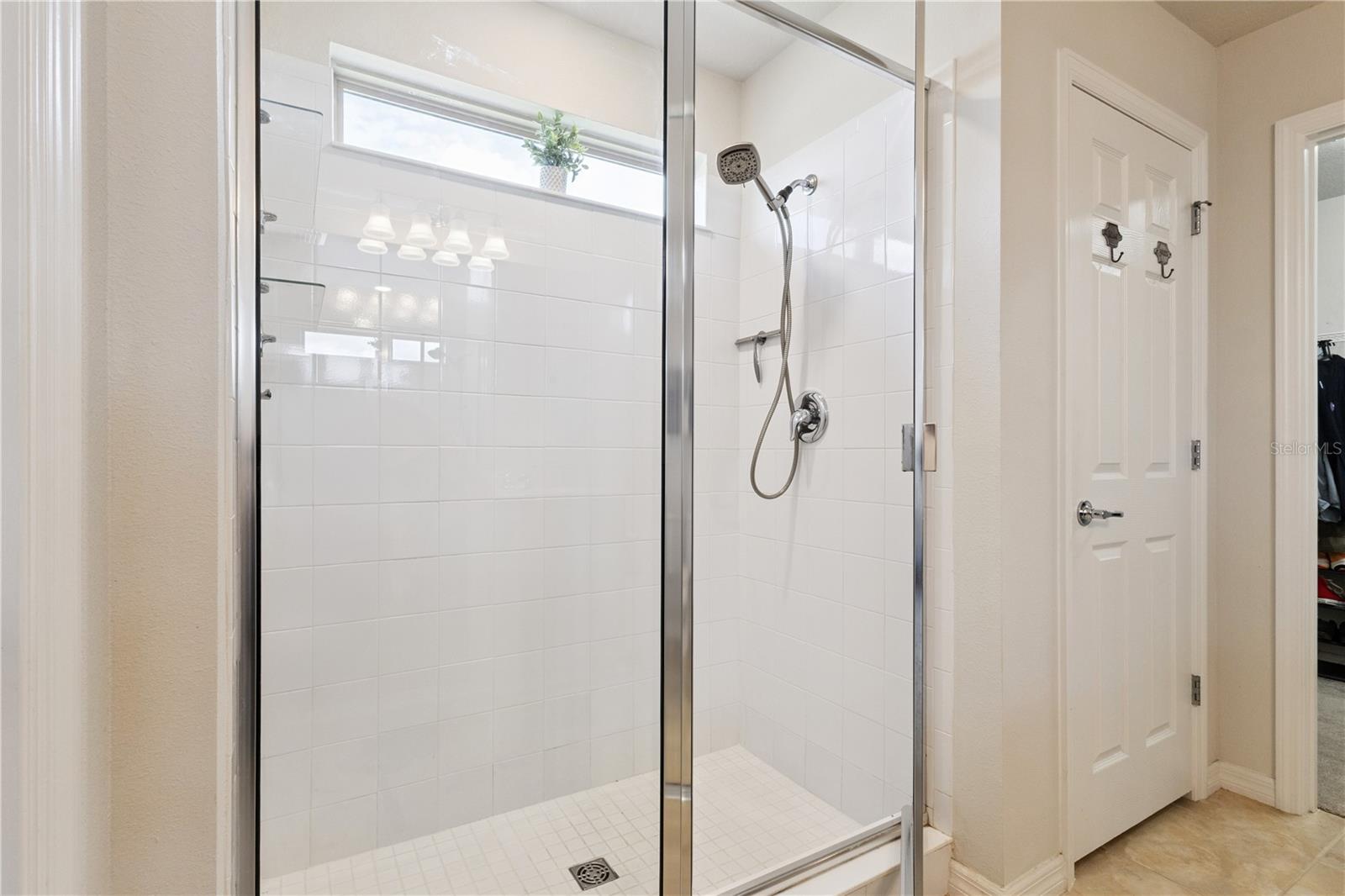 Walk in Shower in Primary Bath with window adding natural lighting