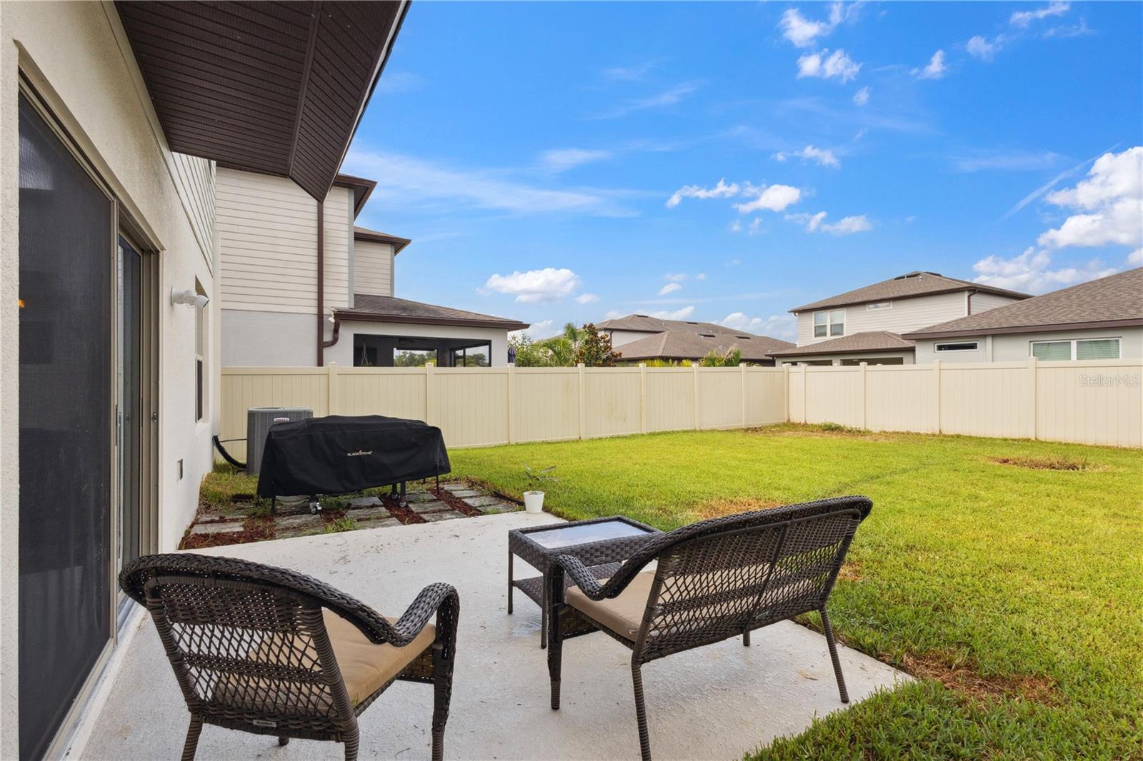 Outdoor Patio opening to spacious fenced-in backyard