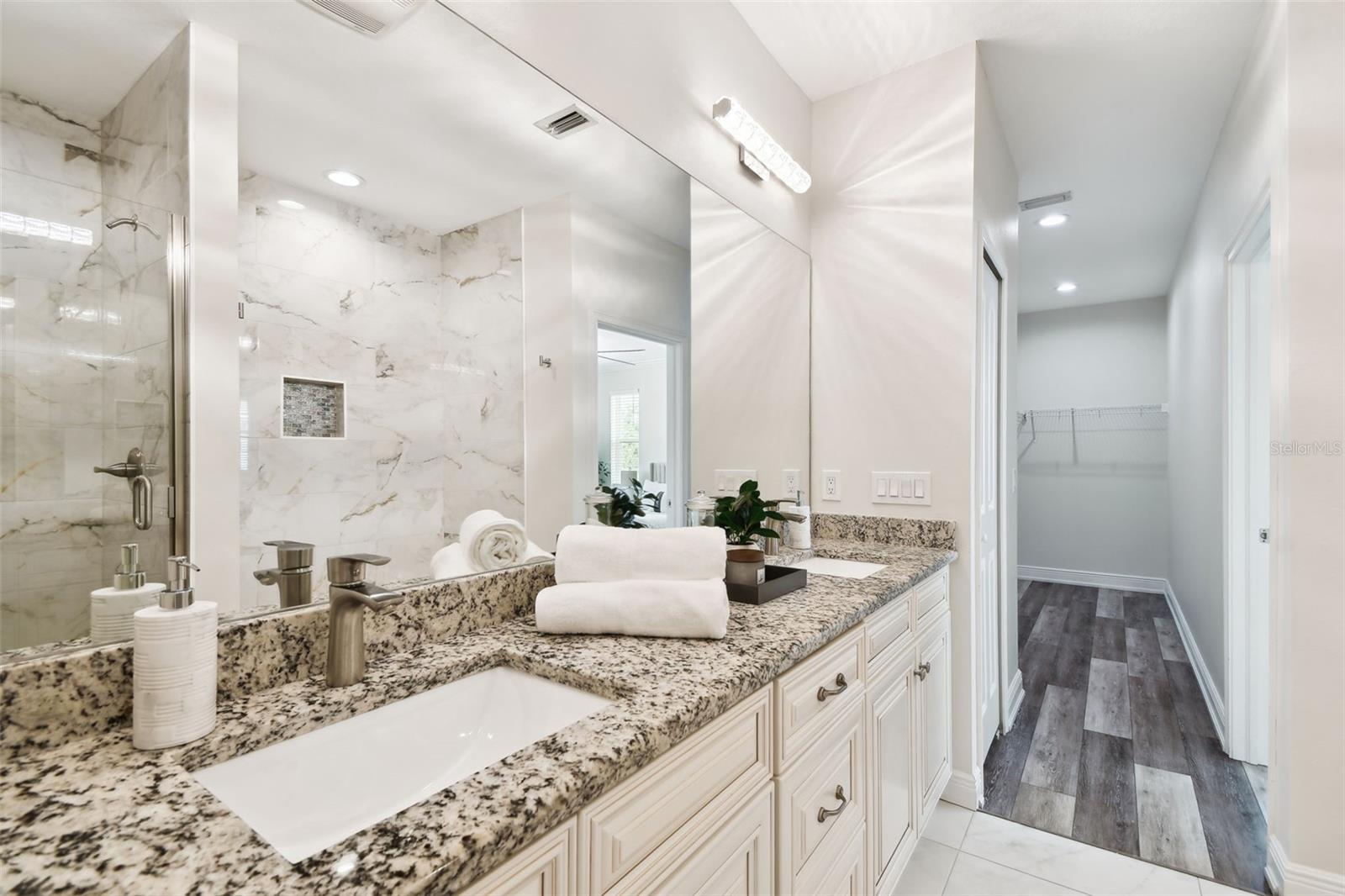 Primary Bath contains dual sinks with luxurious custom tile and finishes