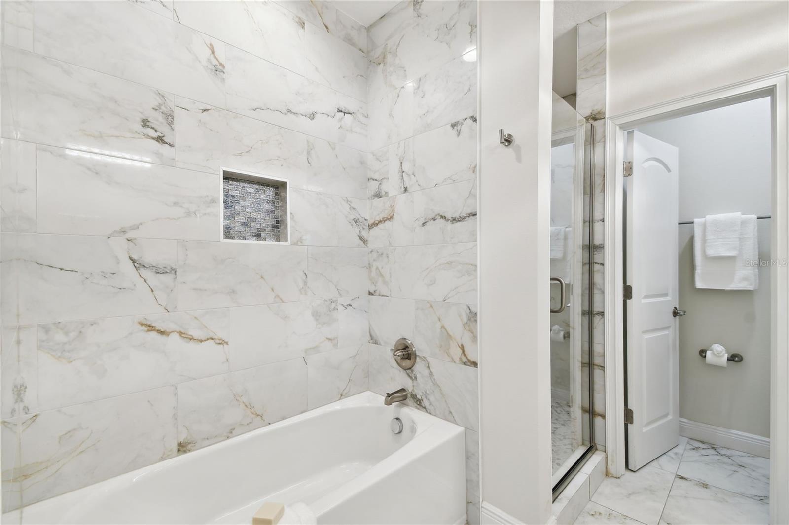 The Primary bath also contains a garden tub, walk-in shower, and water closet.