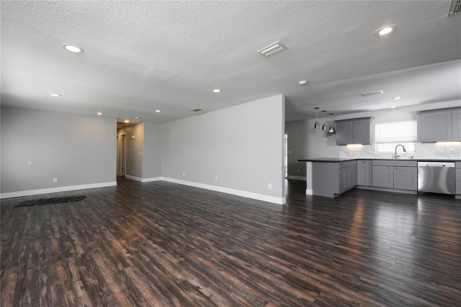 View of Living Room and Kitchen - Hallway to All Bedrooms on Left