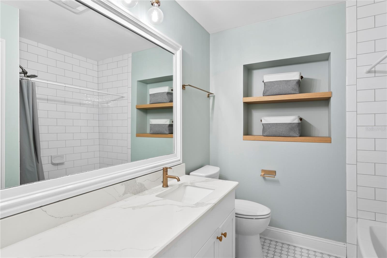 Guest Bathroom that includes quartz counter and built-in tub