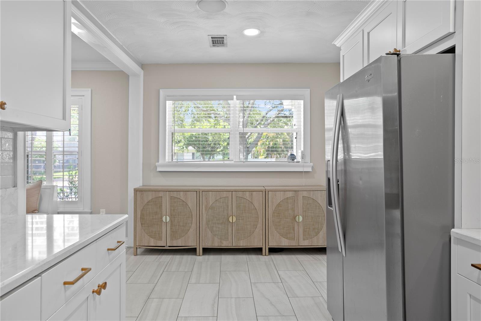 Bright and airy kitchen opens into dining room