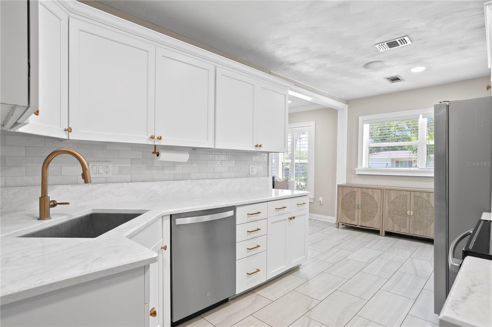 Kitchen showcases white cabinets and quartz countertops
