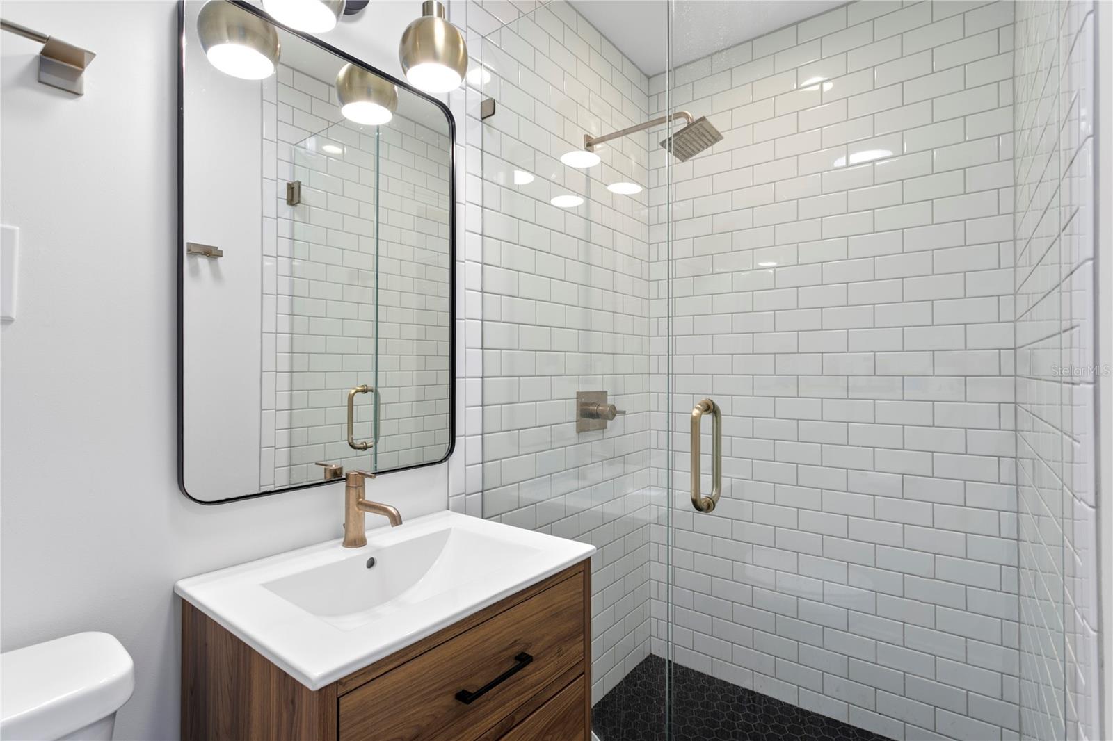 Prmary bathroom with quartz vanity and white subway tile