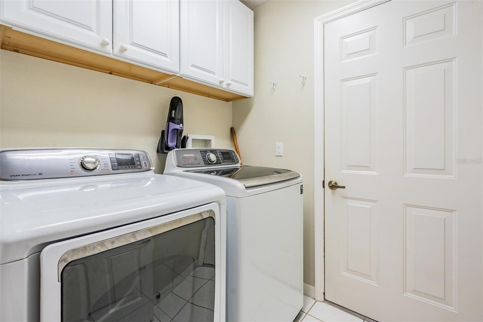 Walk-in laundry room with buillt-ins