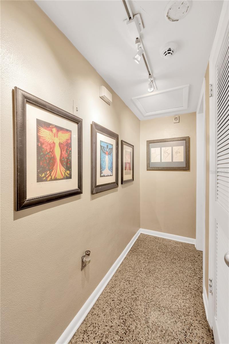 Track Lit Hallway Leads to Primary Bedroom & Bathroom Suite