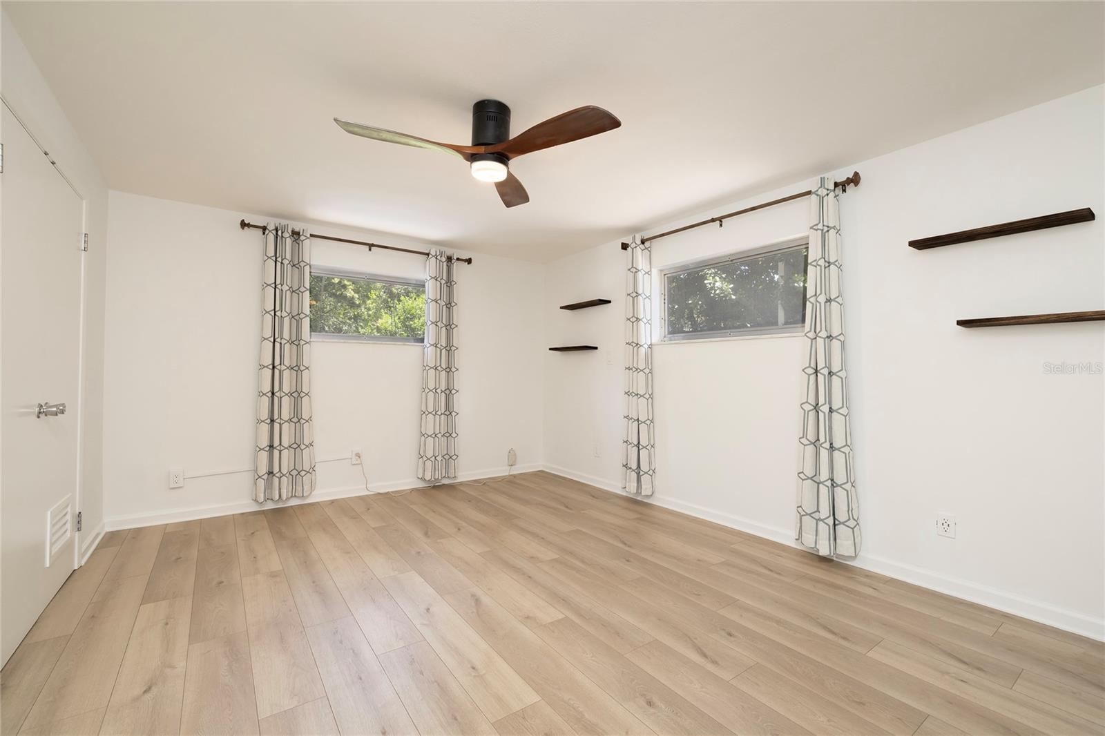 Spacious Primary bedroom with new flooring and paint
