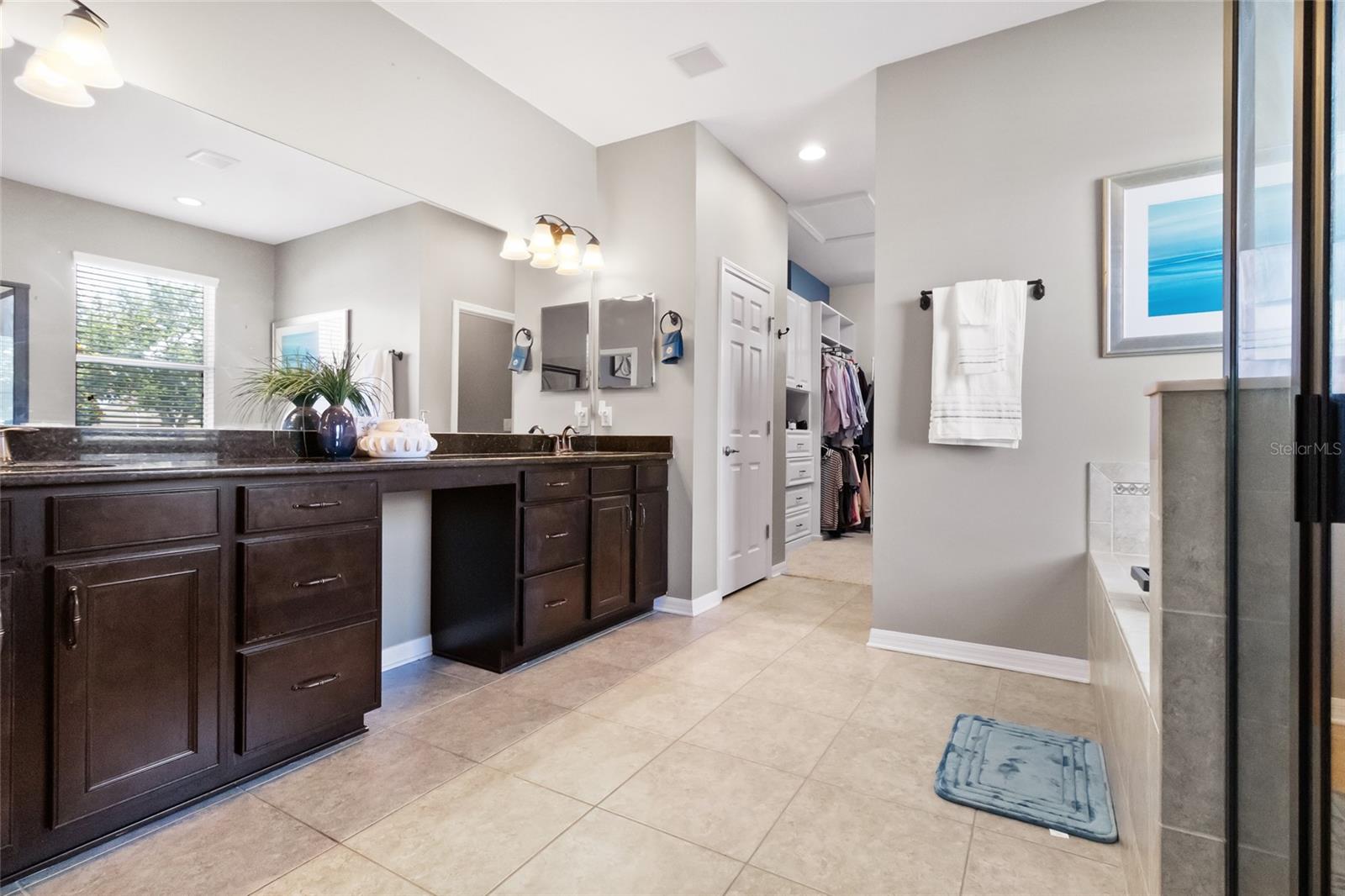 Primary bath with double sinks walk-in shower and soak tub.