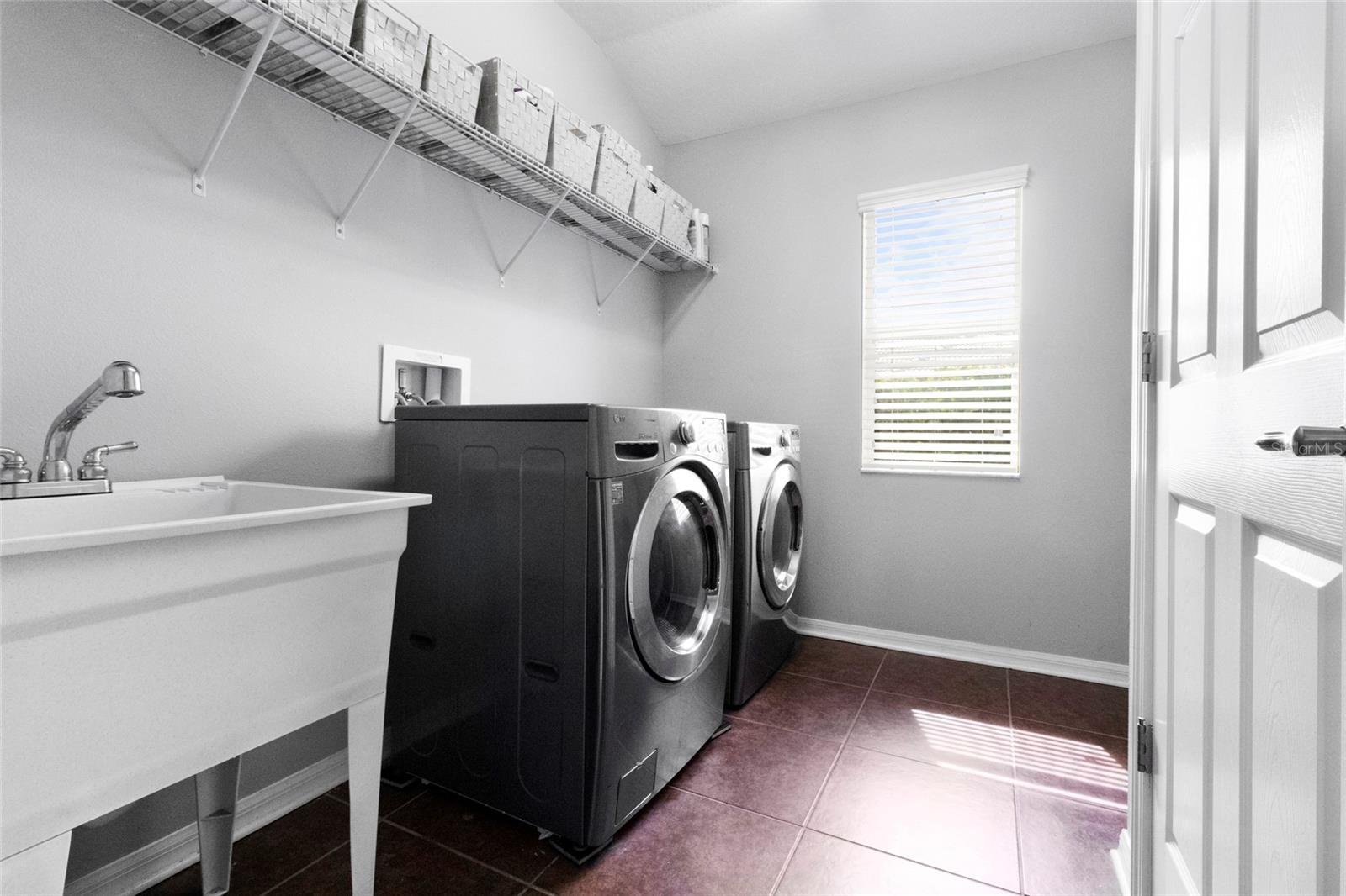 Large laundry with tub sink off of the kitchen.