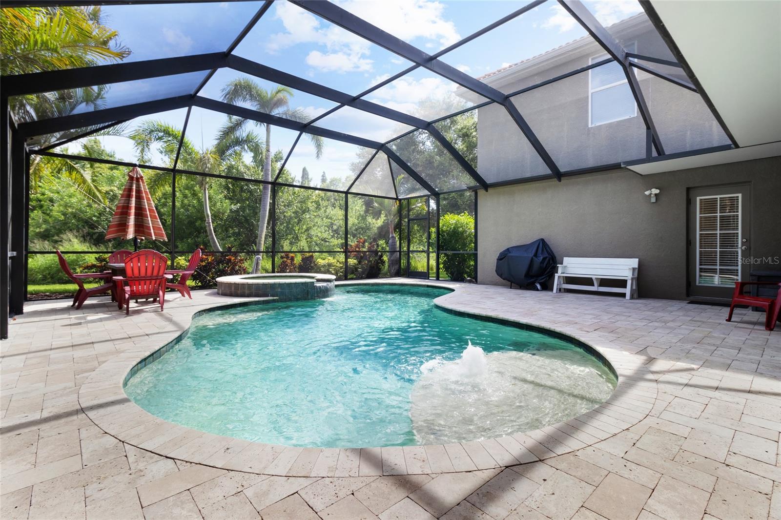Beautiful pool and travertine tile pavers (cool on your feet) with spa tub await!
