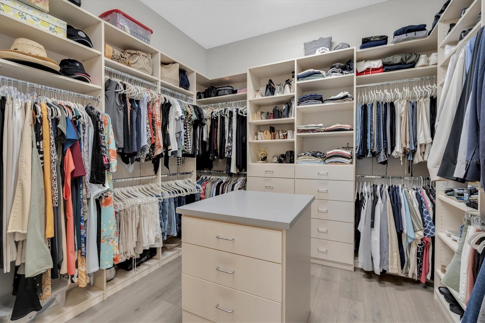 PRIMARY CLOSET WITH BUILT IN ORGANIZERS