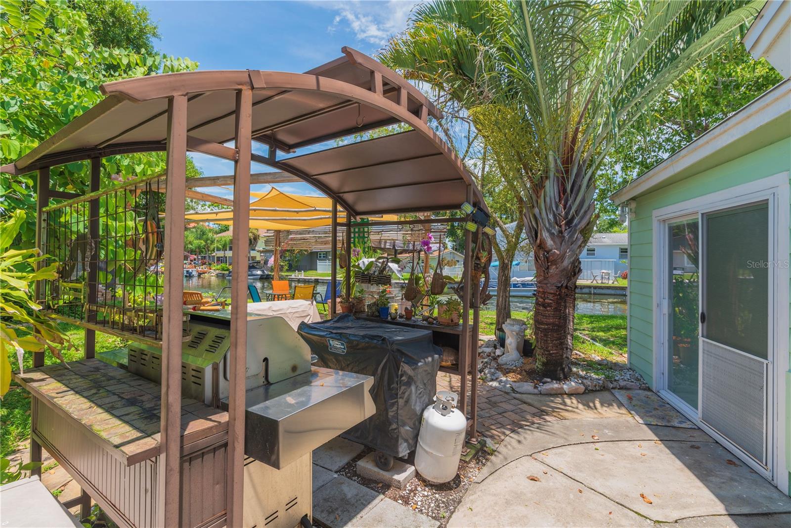 Left side of the property has a patio with covered grilling area (grills do not convey).