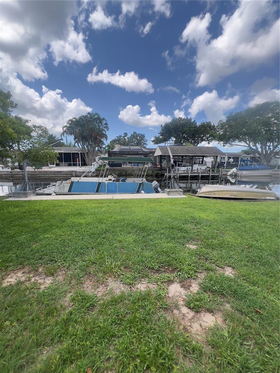 Boat davit on right side of property next to wooden observation deck.