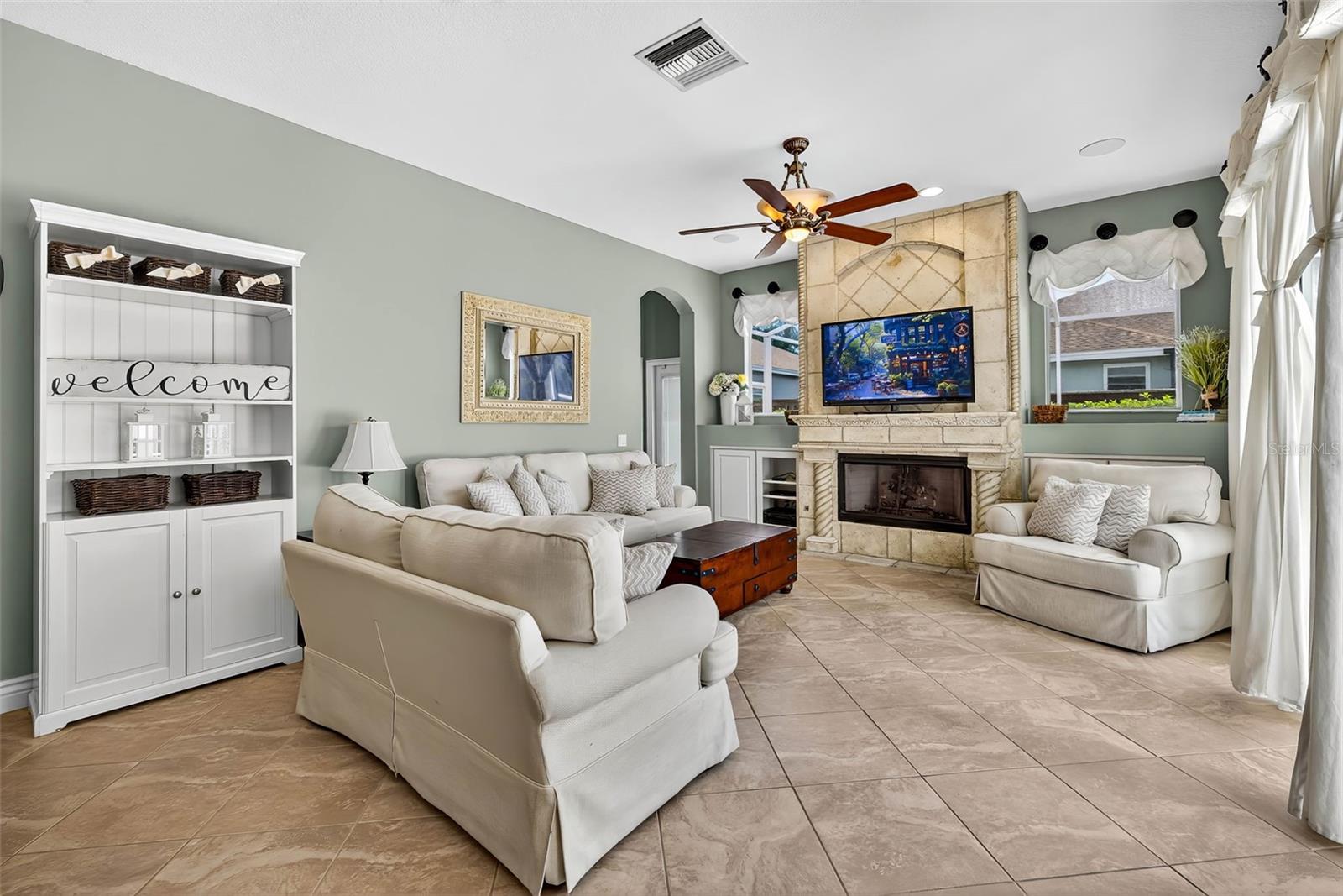 Family room with gas fireplace and access to pool