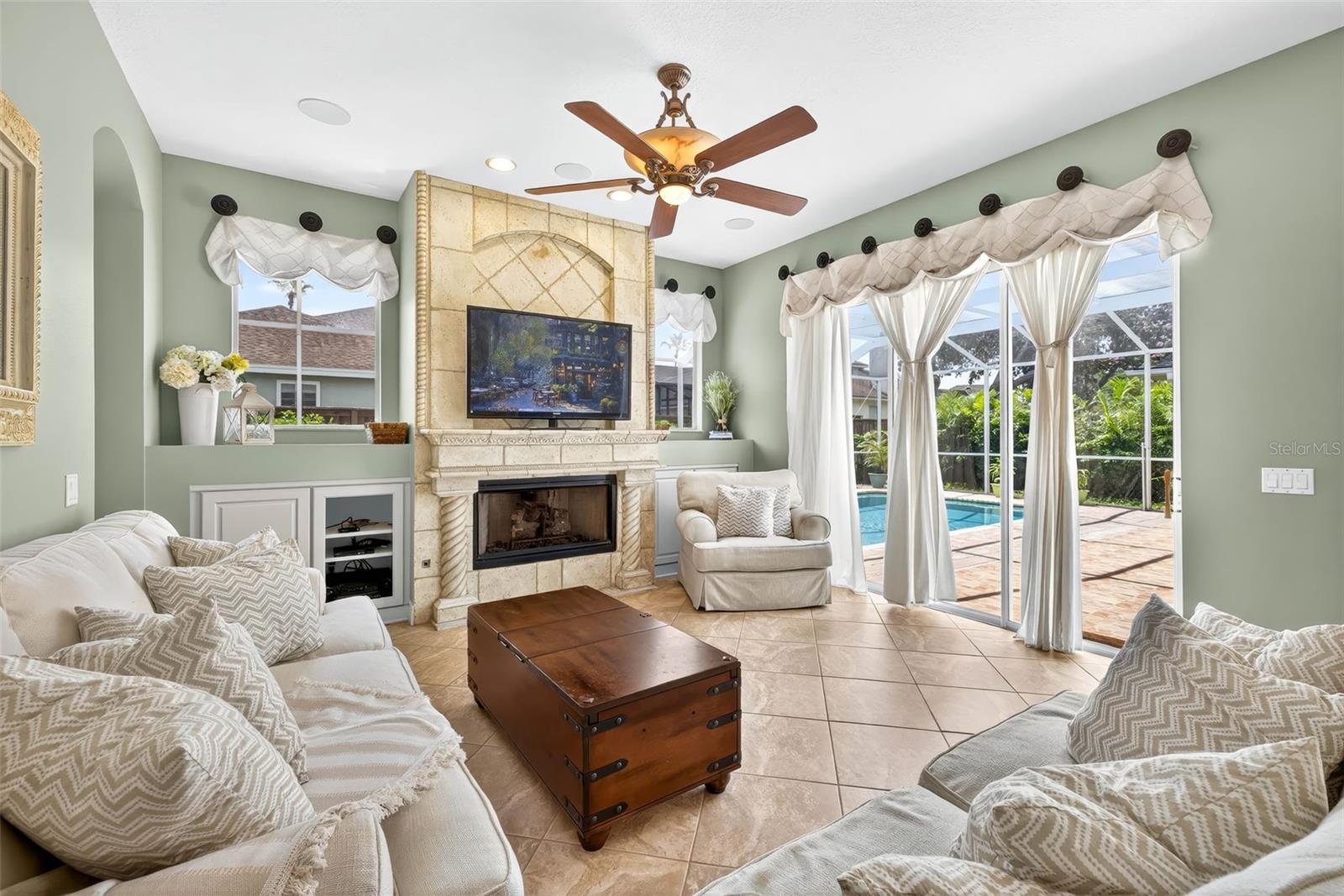 Family room with gas fireplace and access to pool