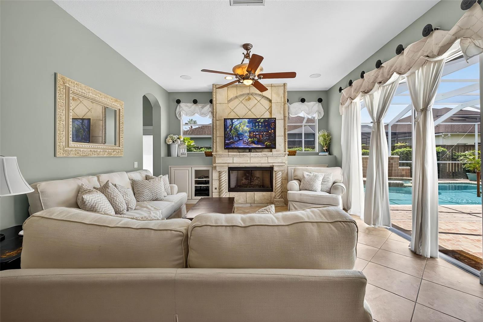 Family room with gas fireplace and access to pool