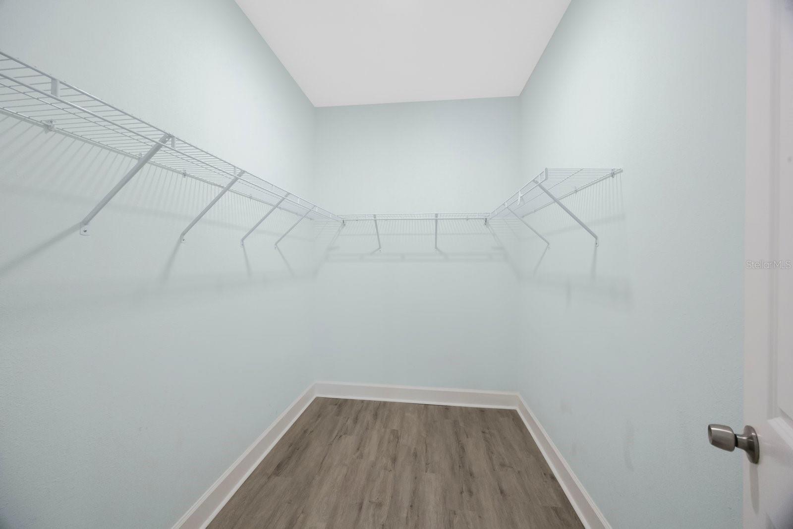 Primary walk-in closet for ample space & organization