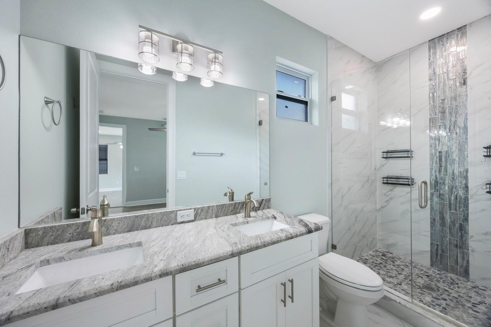 Primary bath en suite with dual sinks & more than enough cabinet space
