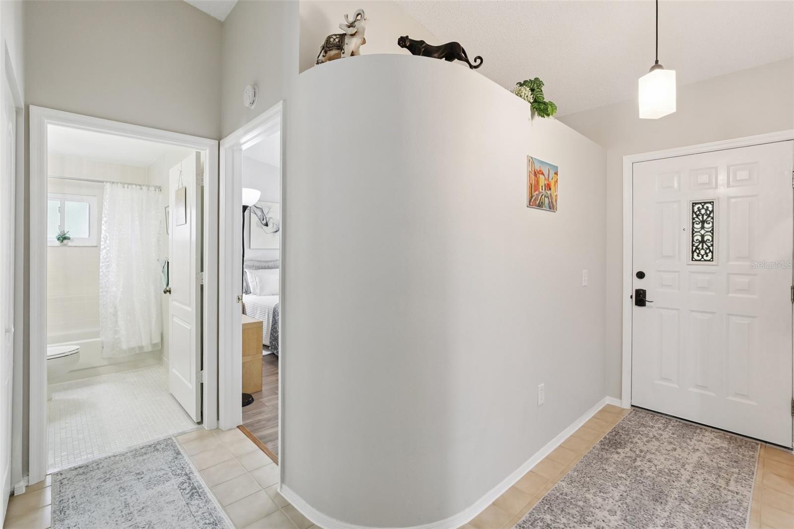Cross-section view of front door to the right and guest area to the left.