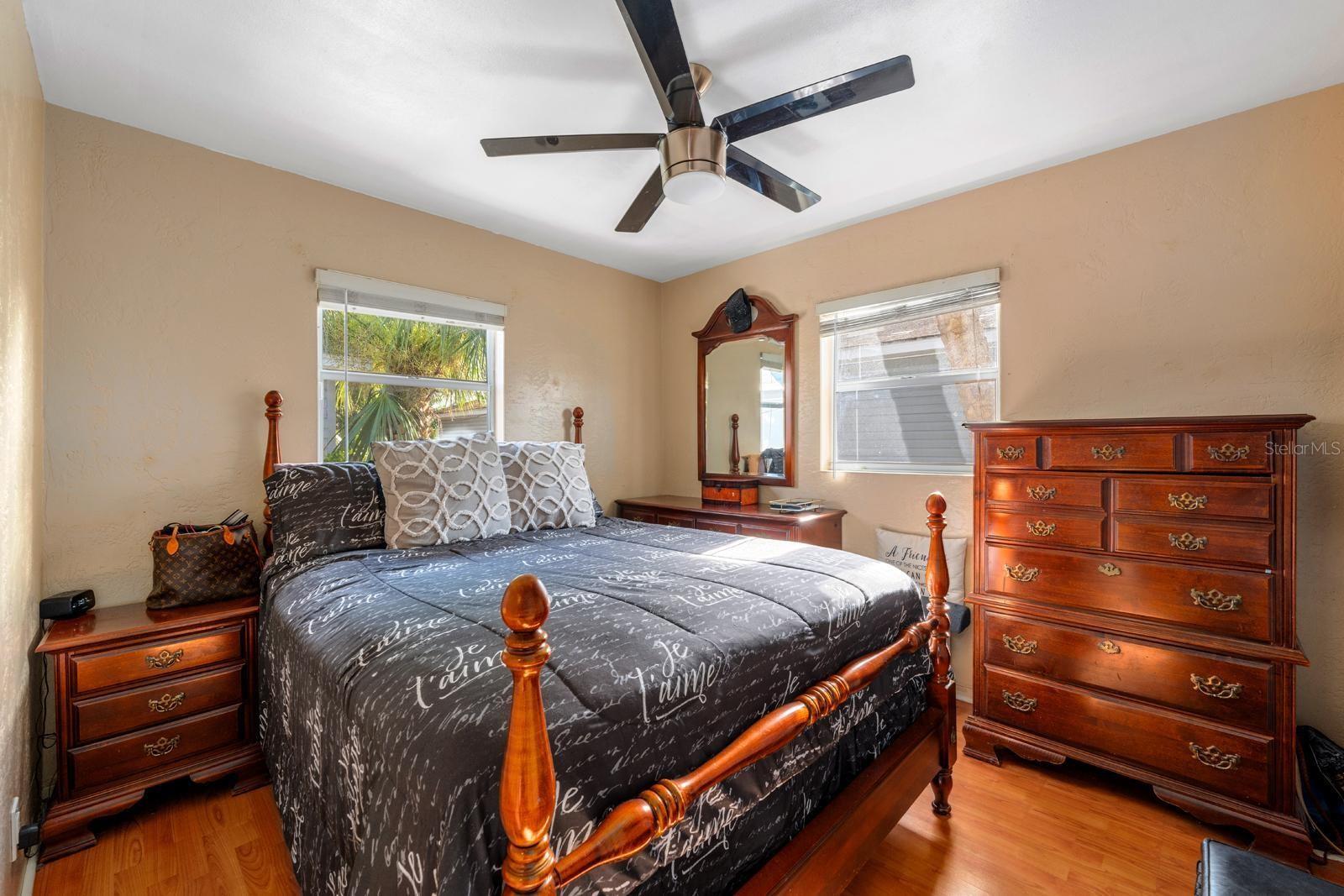 This bedroom features calming tones, ample natural light, and a comfortable layout—ideal for rest and relaxation.