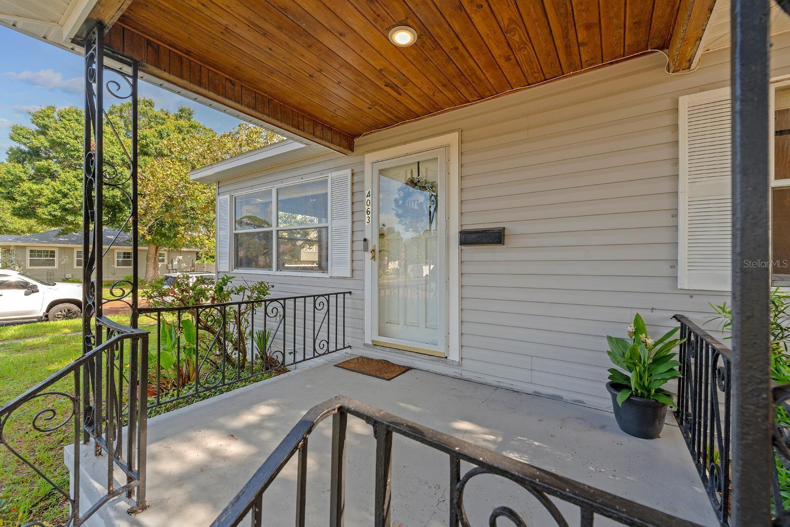 The cozy front porch adds charm and character, offering just enough space for a rocking chair and a warm hello.