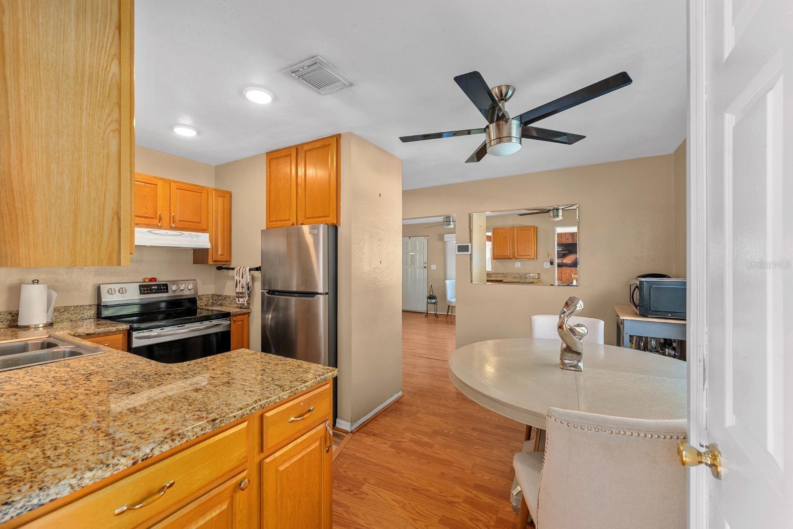 The efficient kitchen features granite countertops, ample cabinet space, and a functional layout that maximizes every inch.