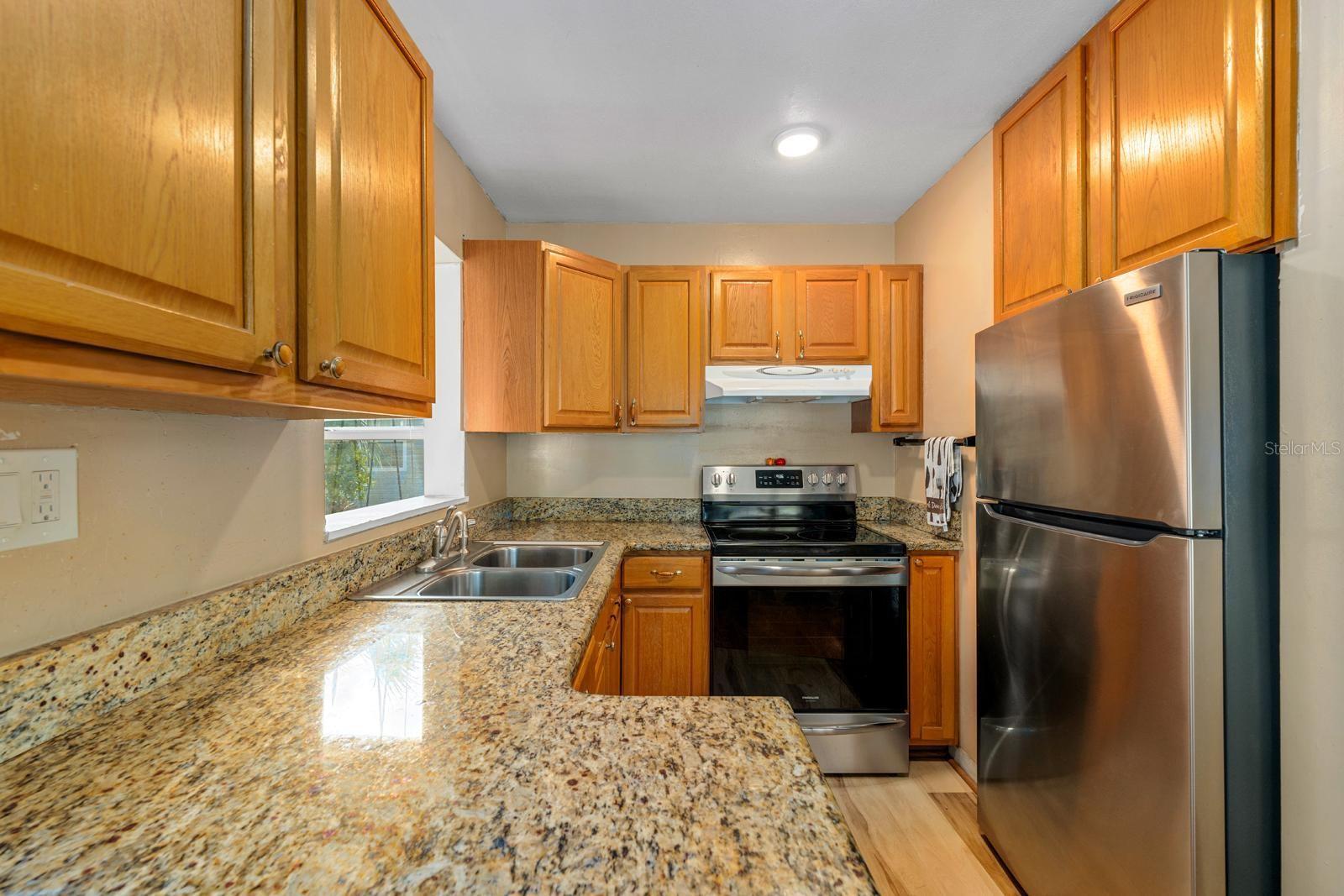 Kitchen features beautiful cabinetry, ample counter space, and sleek stainless steel appliances that blend both style and function.