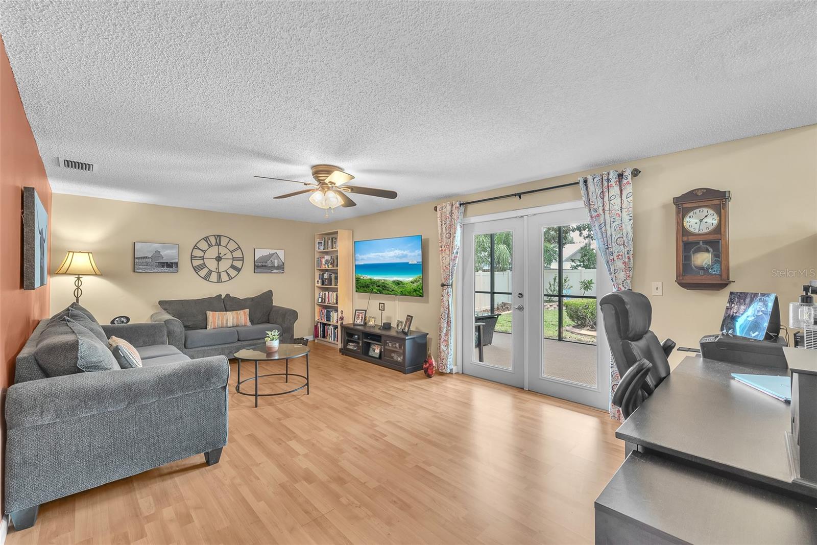 This large family room with french doors opening to a private back screened porch is located on the lower level of this tri-level home.