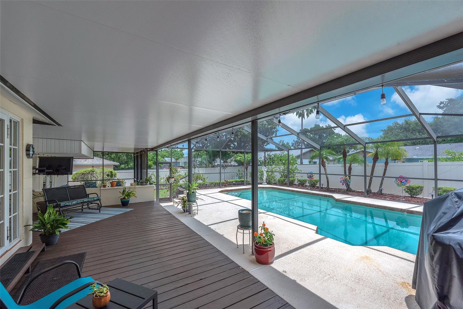 The adjacent covered porch with decking is perfect for grilling or relaxing and is spacious. The entire ceiling spanning both outdoor porch areas has been re-surfaced.