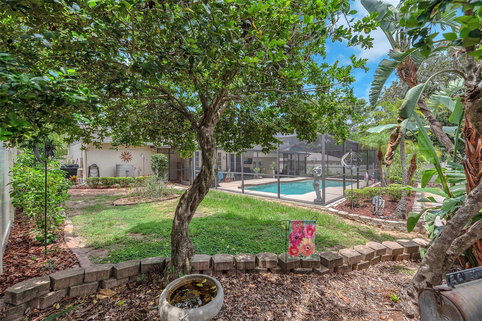This fully fenced, park-like backyard will keep your green thumb happy.