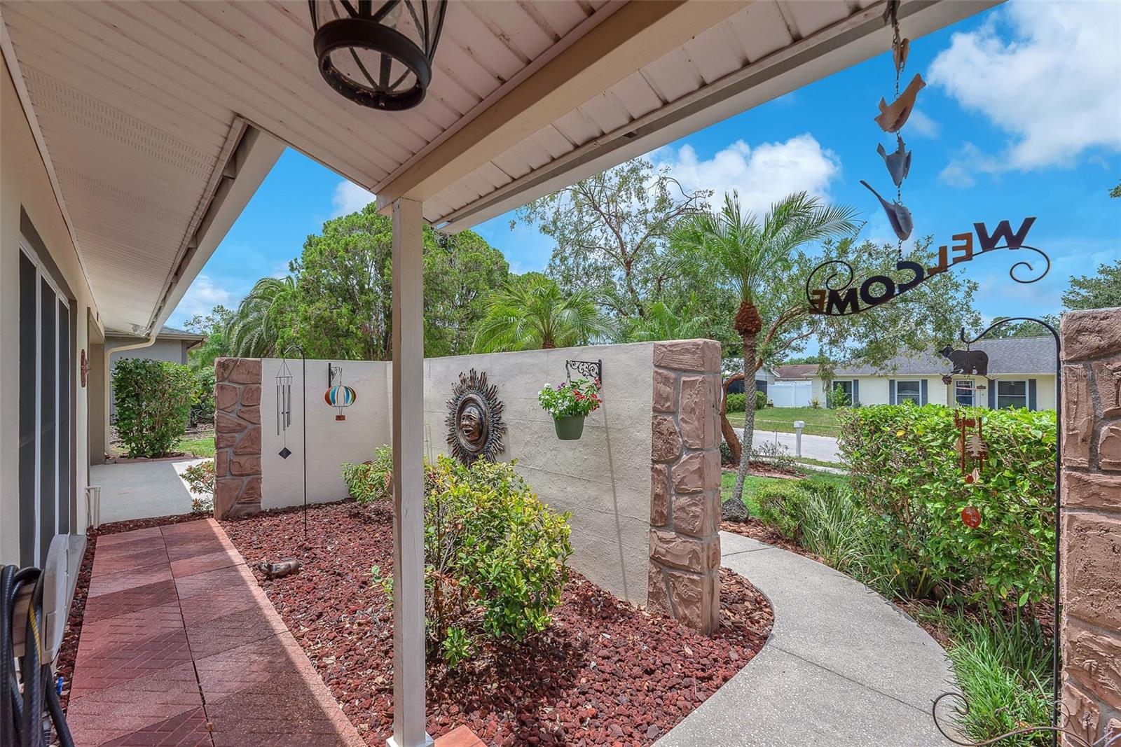Take a moment to enjoy the peaceful front courtyard thoughtfully landscaped to create a private, screened-in retreat and privacy from the street.