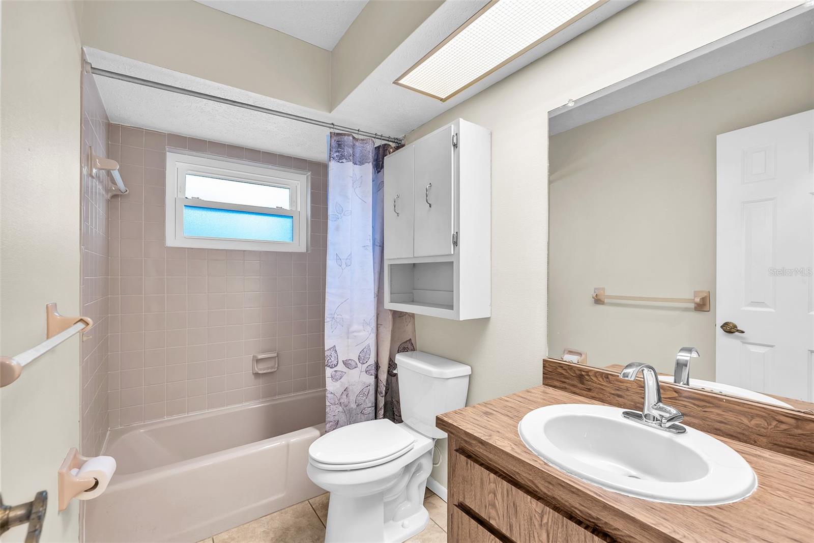 Guest bathroom with tub/shower combination.