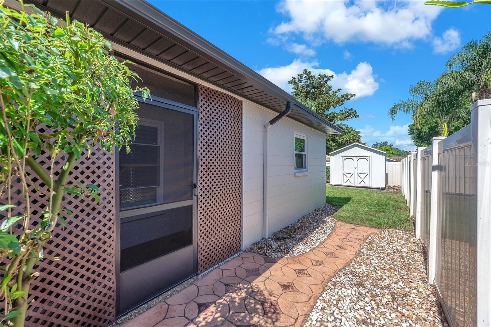 Side screened door from breezeway to side yard is perfect for letting the furry family members outside!