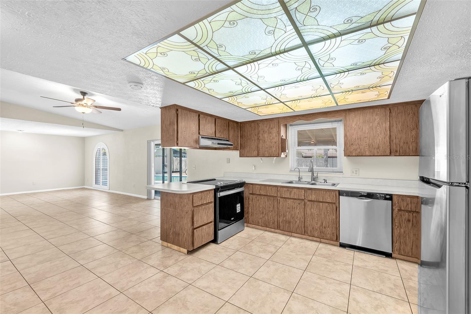 Eat-in kitchen is conveniently located near the dining room and flows seamlessly into a large family room with a vaulted ceiling.