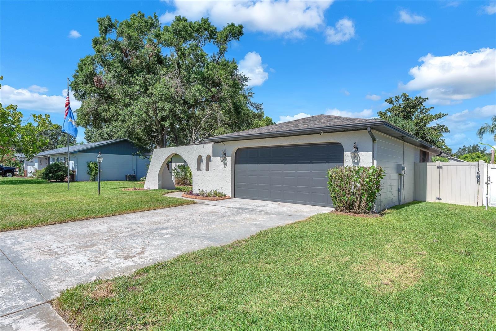 Included with the home are thoughtful extras like a prominent flagpole in the front yard, an eagle statue overlooking the pool, a Ring doorbell, security system, motion-sensor exterior lighting, and a spacious utility room complete with washer and dryer, built-in cabinetry, and a pet door that leads to a unique breezeway connecting to the 2-car garage.