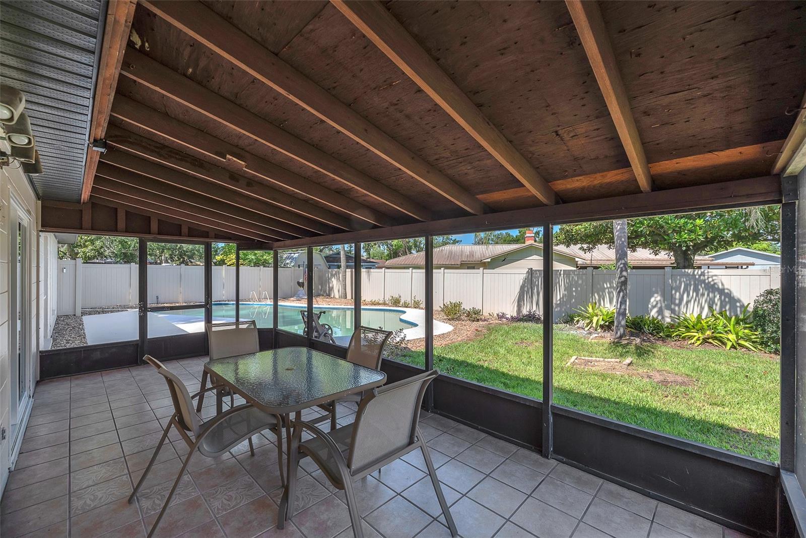 The spacious 22' x 9.6' screened-in porch offers plenty of room to relax, and comes complete with patio furniture and an outdoor grill, all included with the home.