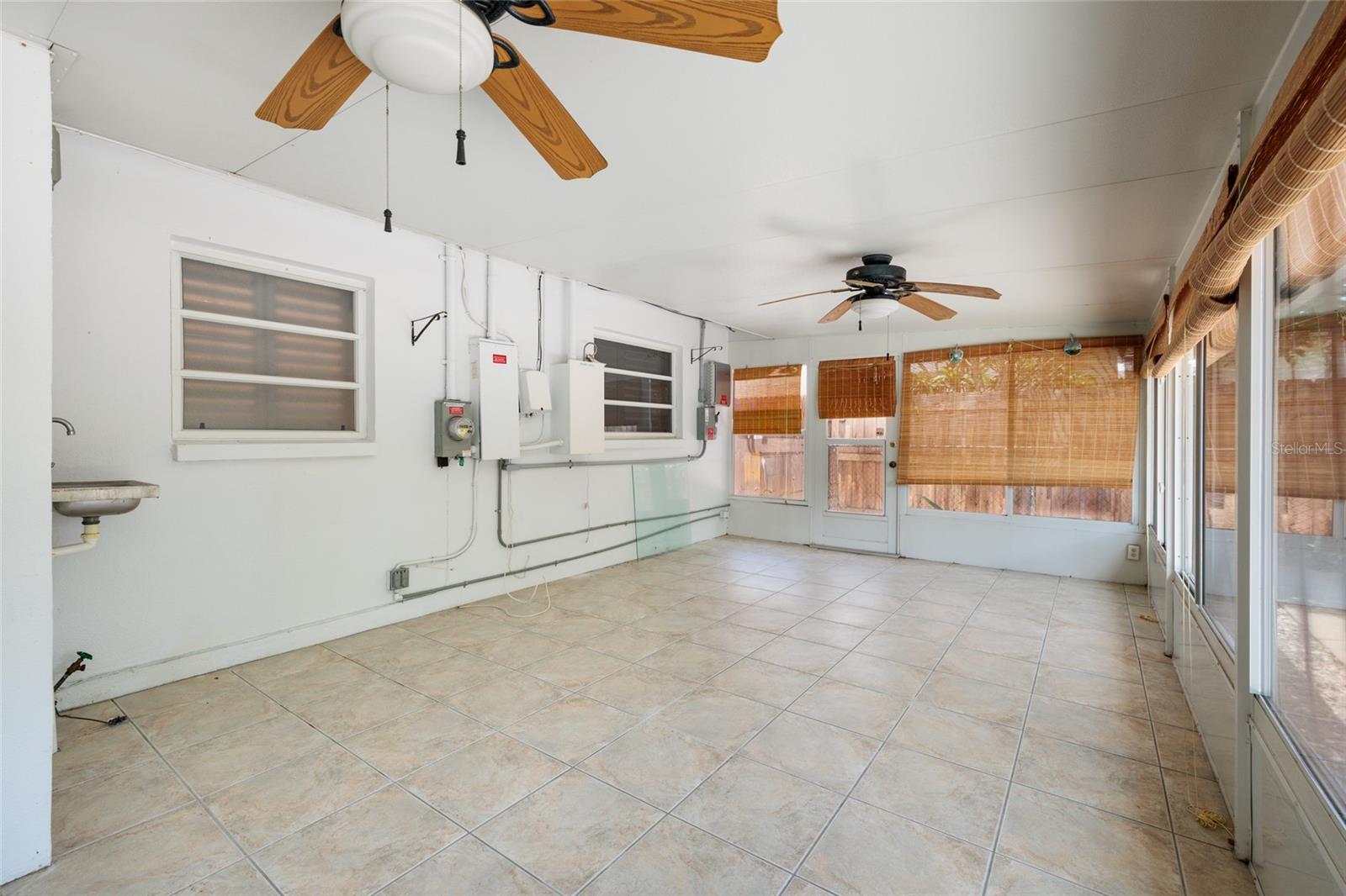 Large back glass enclosed porch overlooking back yard.