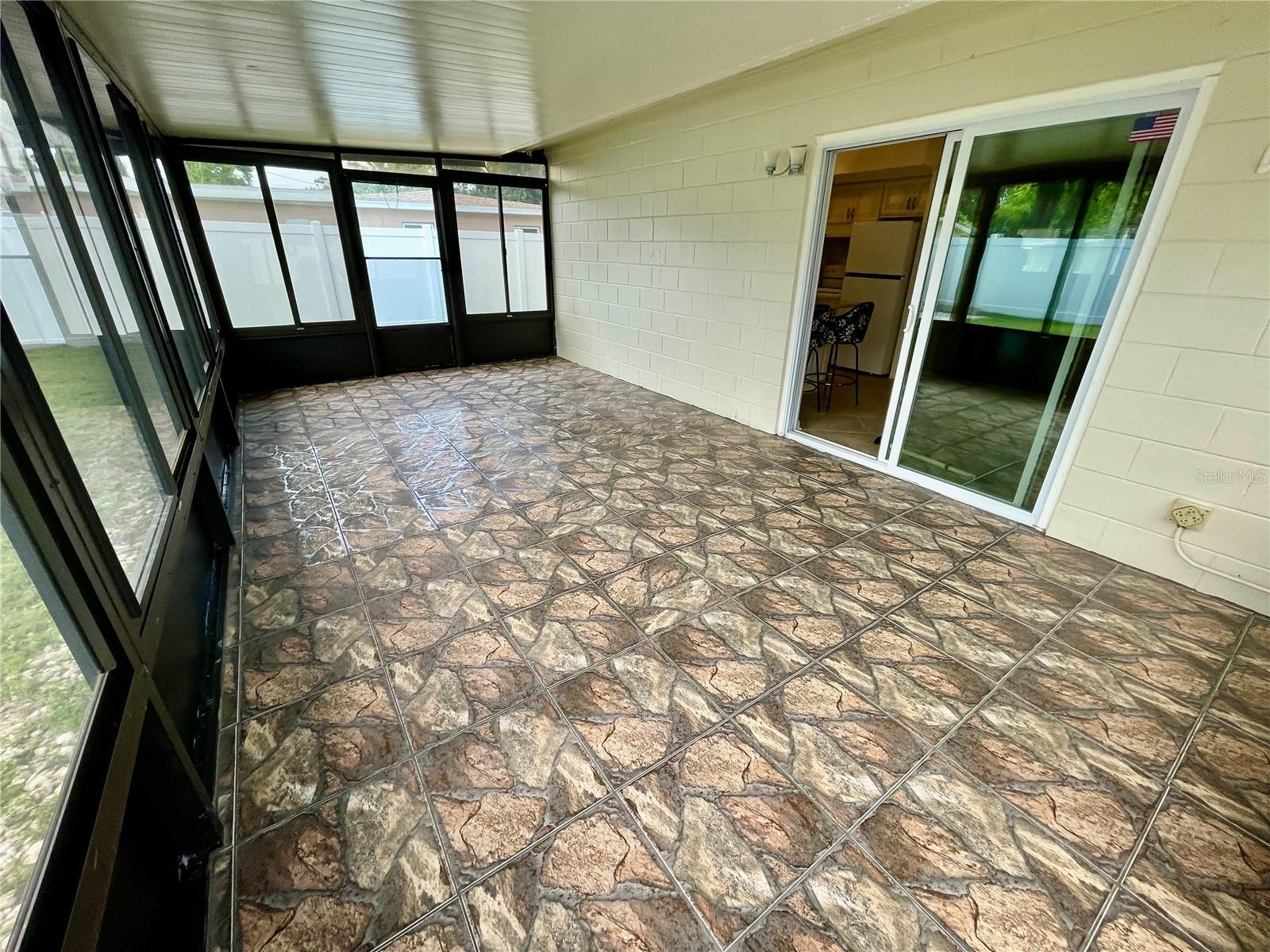Family room, screens, windows, and ceramic tile.