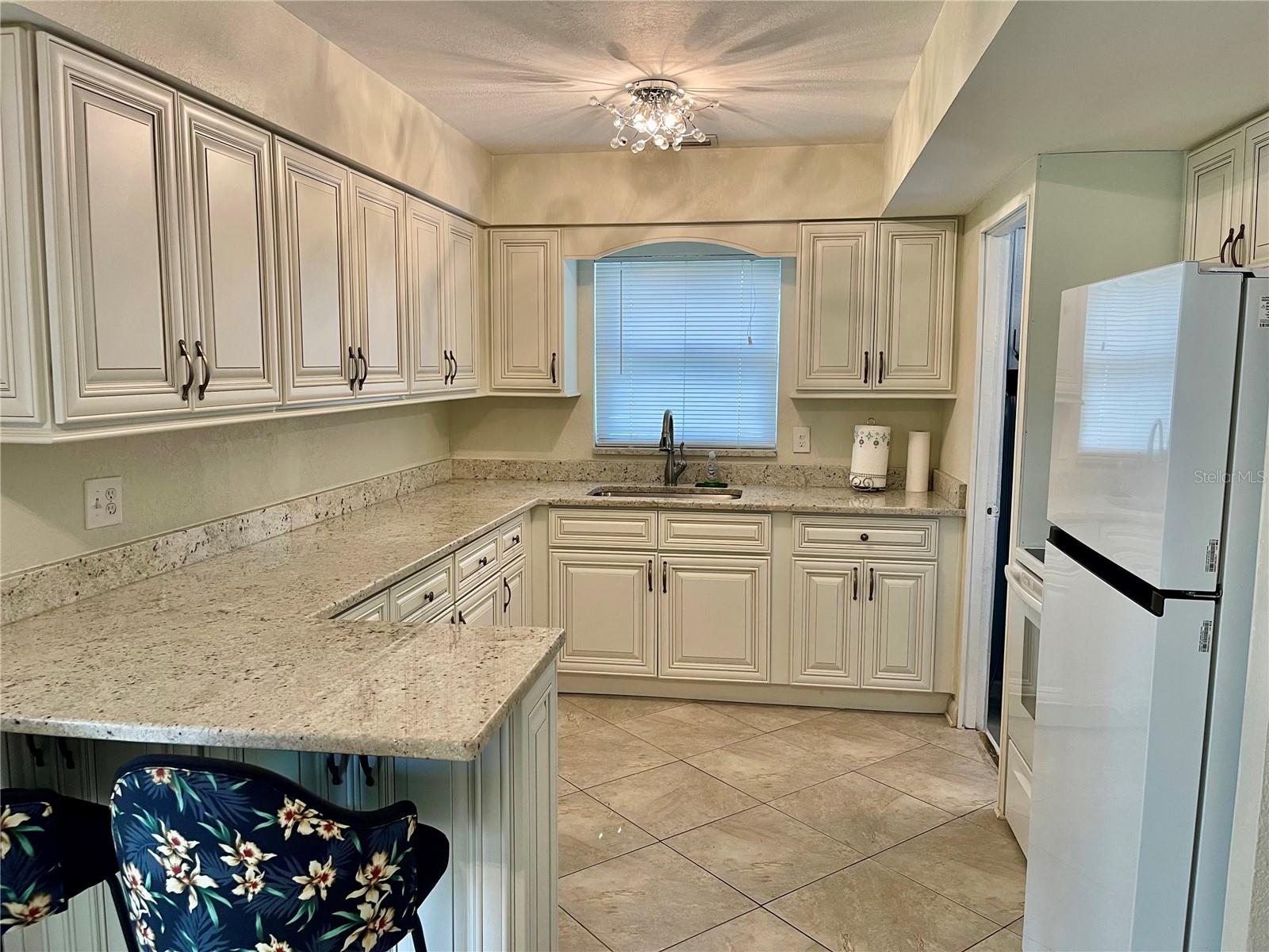 Beautifully updated kitchen, wood cabinets and granite countertops!