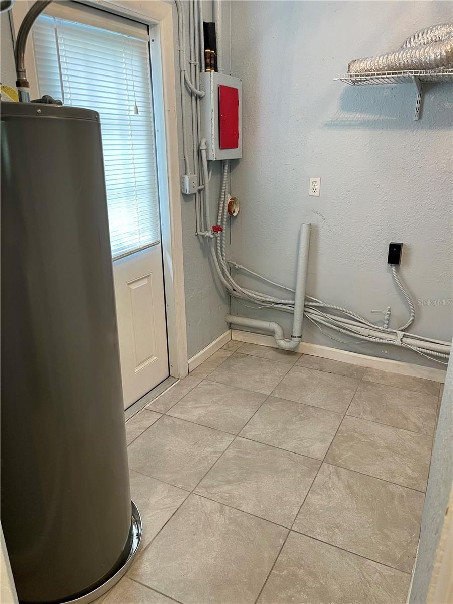 Newer water heater, side door to the patio
