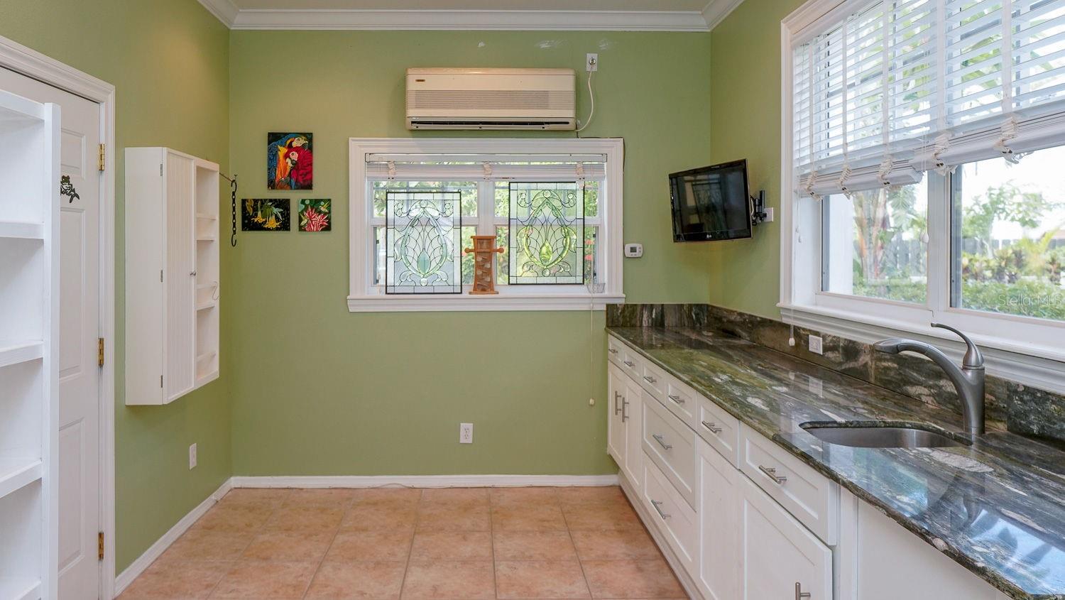 Laundry room behind the wet bar area, door to double oversized car garage
