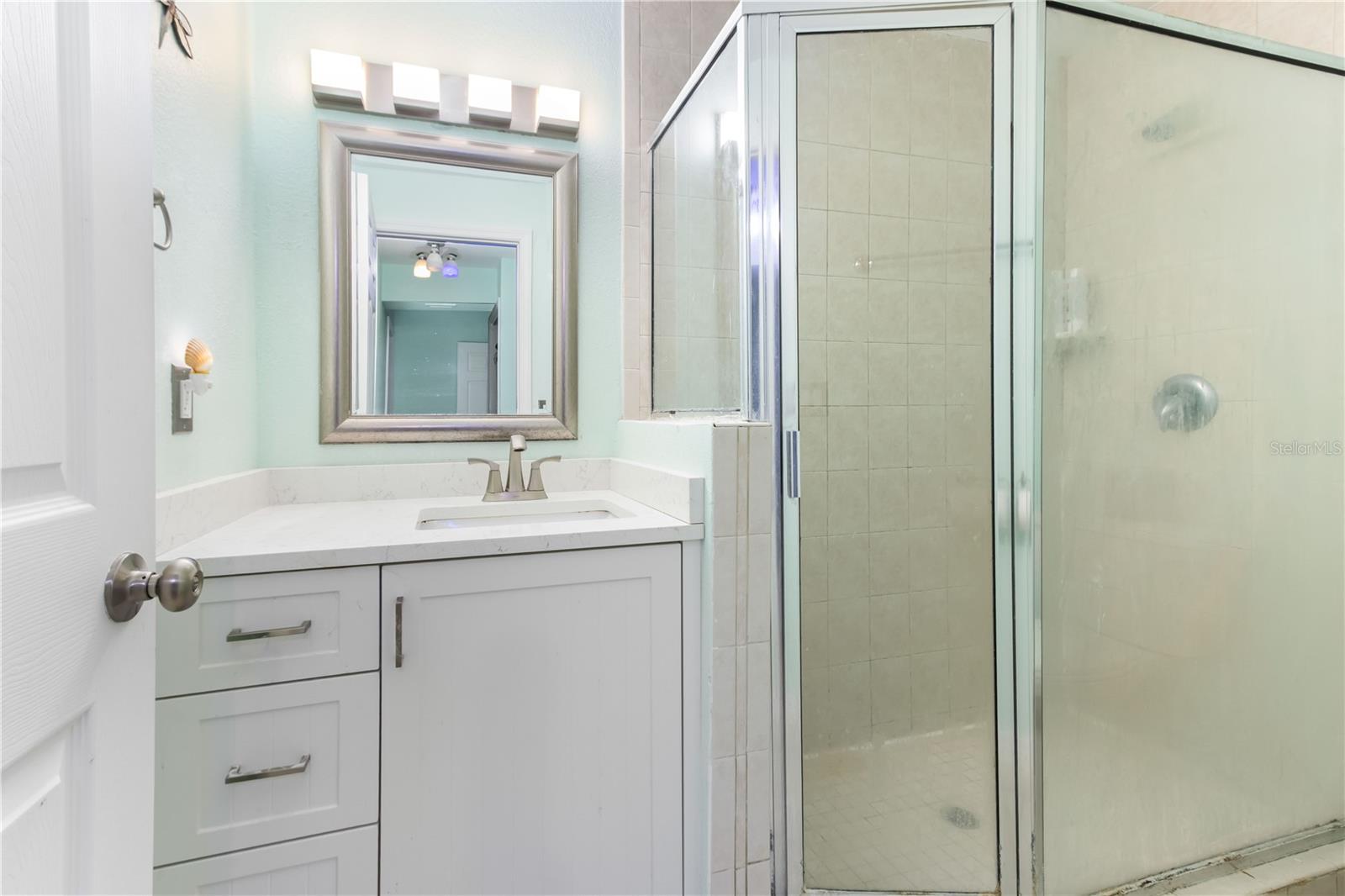 Bathroom 1 with tile and walk-in shower