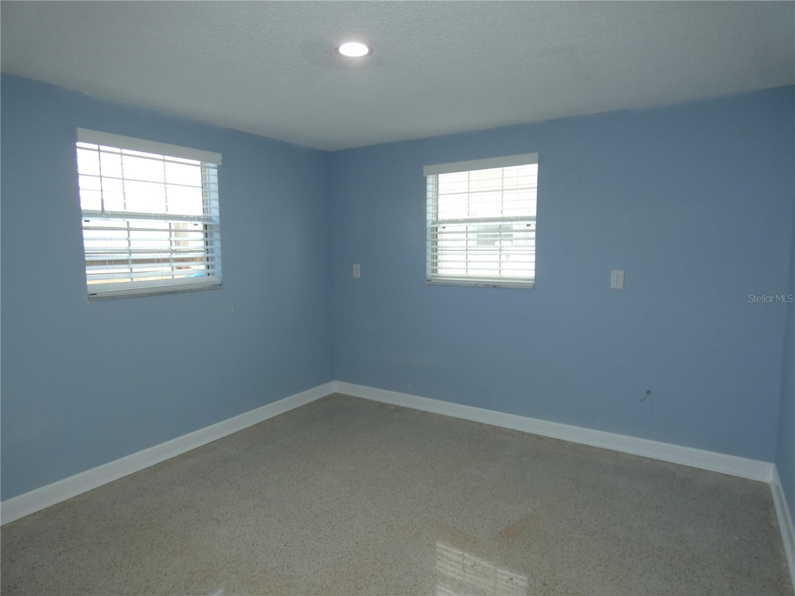 2nd bedroom w/terrazzo flooring overlooking the water.