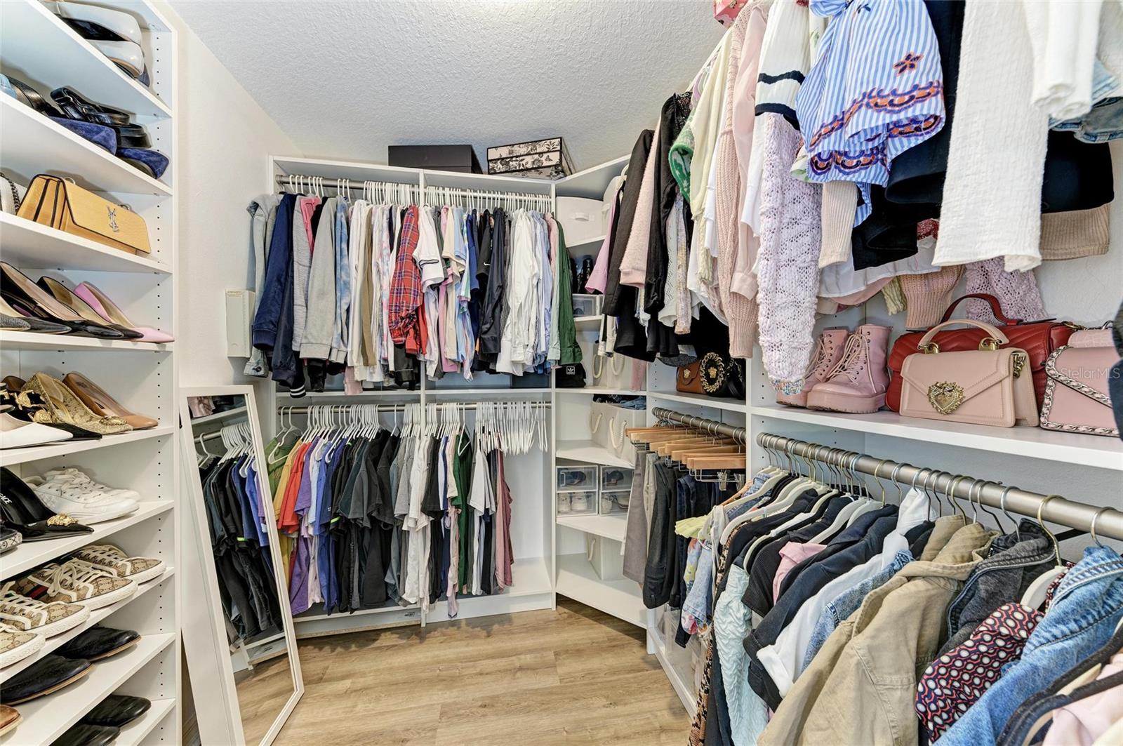 Primary Suite walk in closet with custom built ins