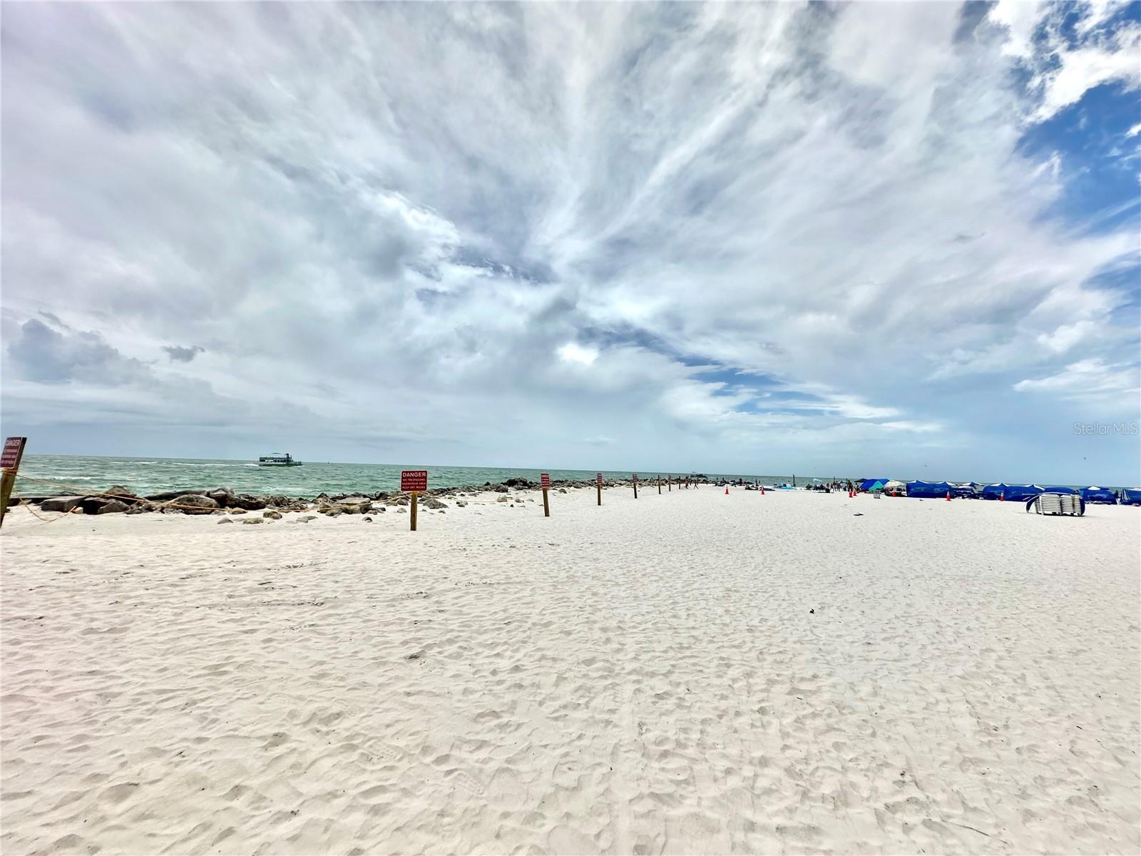 The beach with public parking across from the complex